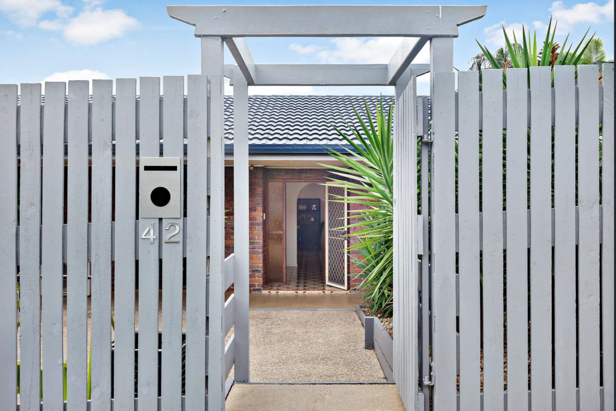 Modern gate leading to house entrance