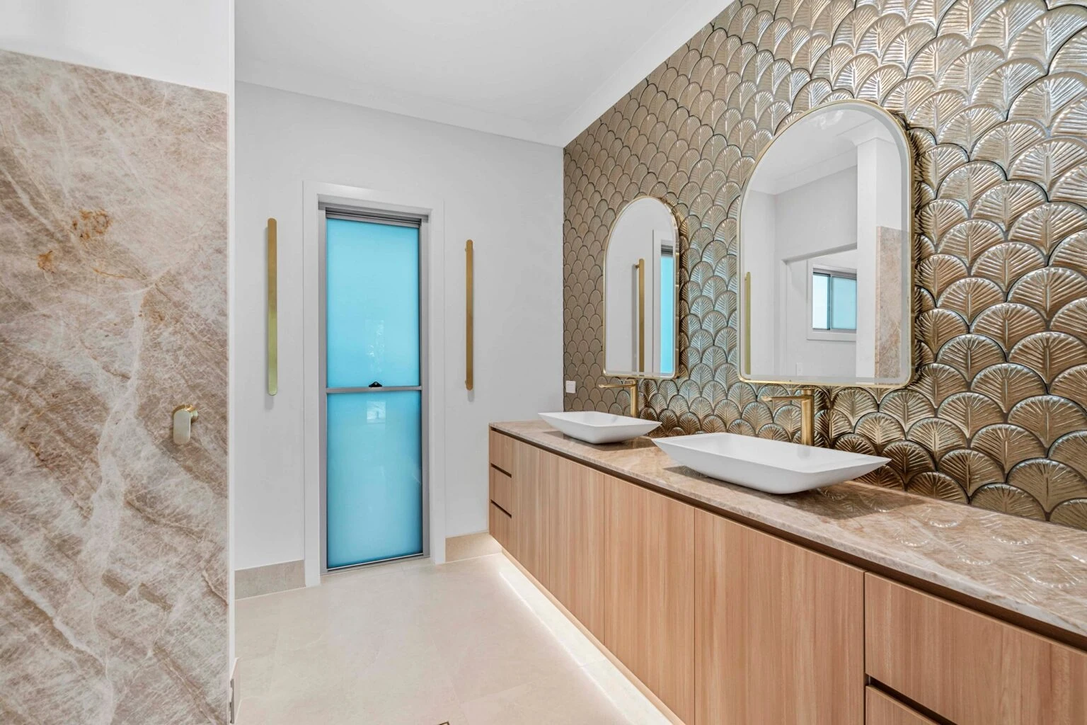 Double vanity with arched mirrors and feature tile wall at the Ney Road renovation, Capalaba