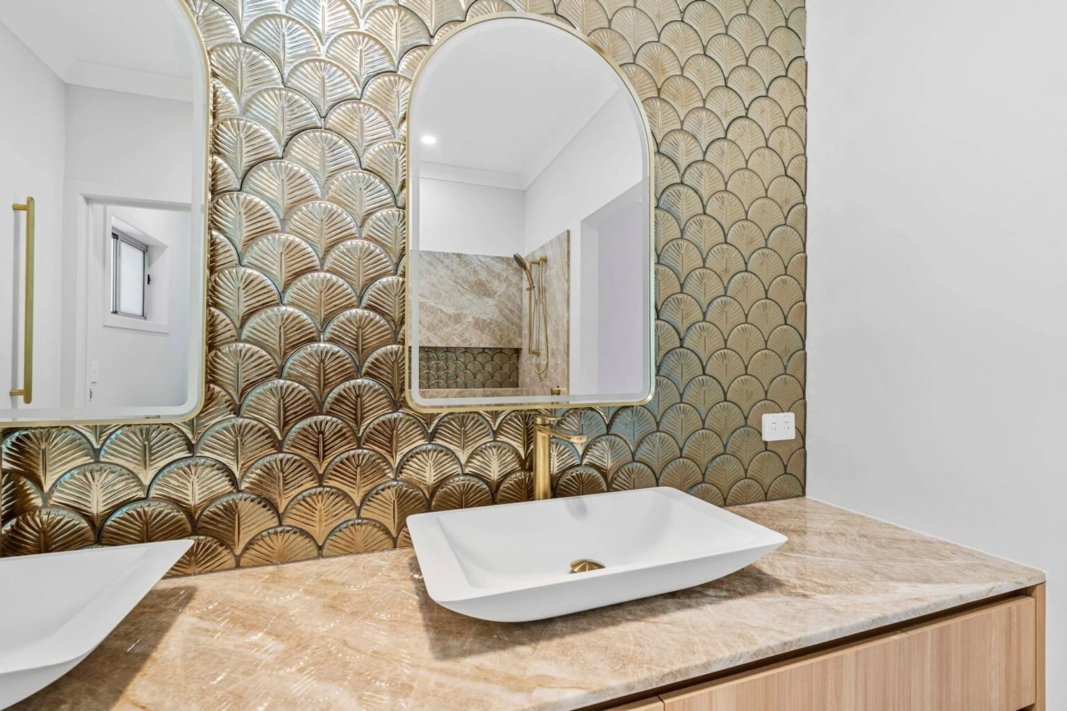 Vessel basin and arched mirror against the feature tile wall at the Ney Road renovation, Capalaba
