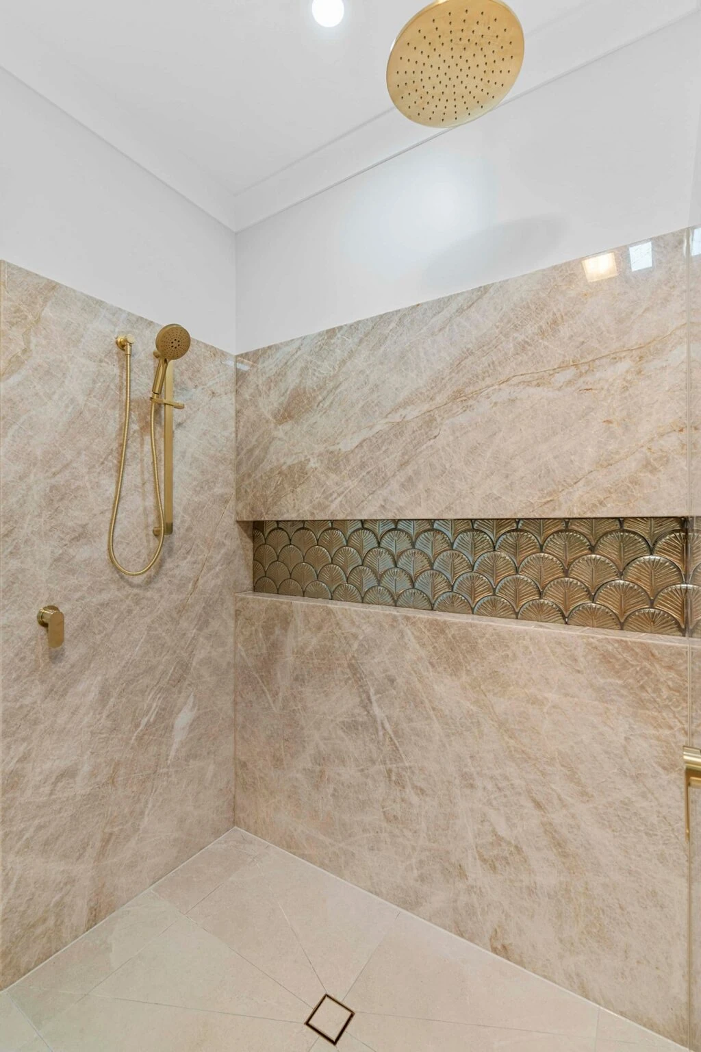 Stone-lined shower with fan-pattern feature tile insert at the Ney Road renovation, Capalaba